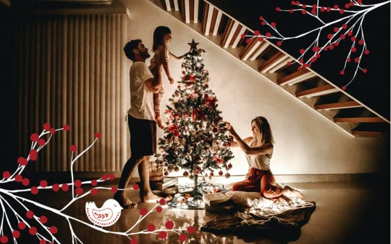 Family decorating a Christmas tree in their home