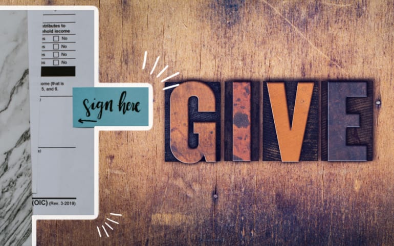 GIVE letters next to paperwork for Christian Financial Advisors newsletter