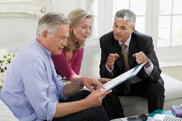 financial advisor counseling a retired couple in their home